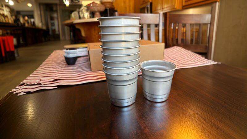 a dozen aluminum cups lined up